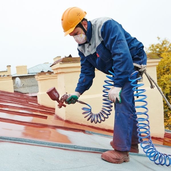 Roof painting by expert roofer applying protective coatings by Roofing Guys Gold Coast