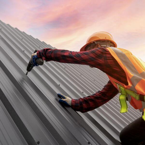 Roofing Guys Gold Coast completing a metal roof installation on the Gold Coast fitting new Colorbond sheets for strength, durability and modern style.