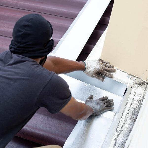Roofing Guys Gold Coast technician repairing flashing during a residential roof maintenance job in Gold Coast.